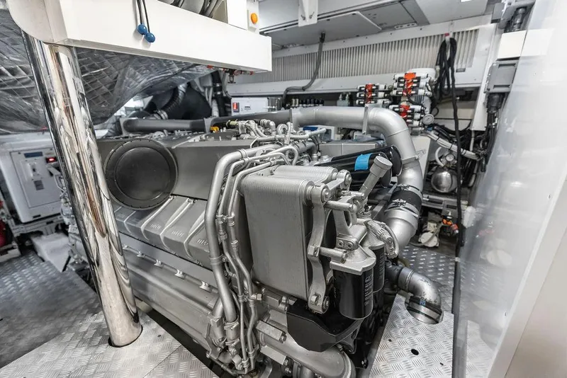 Slide: The Image of Engine room of a 2019 Pershing 9X yacht, showcasing advanced machinery and components. - 95