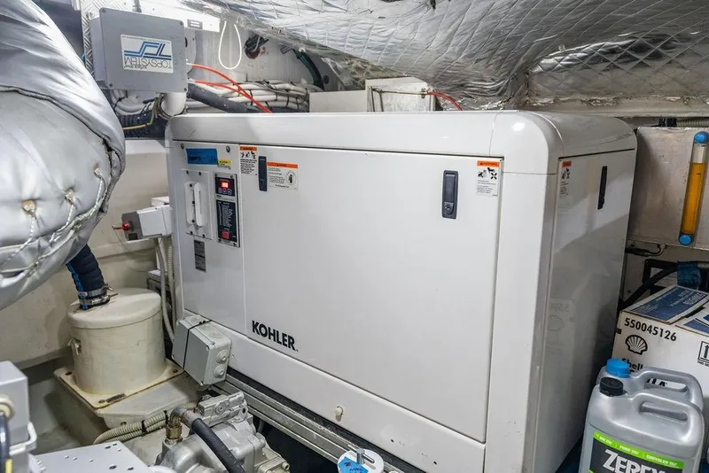Slide: The Image of Engine room of 2019 Pershing 9X yacht featuring a Kohler generator. - 99