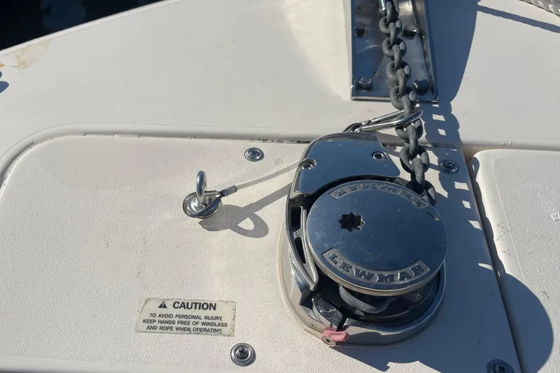 Slide: The Image of 2023 Grady-White Fisherman 236 boat anchor windlass system with caution label. - 10