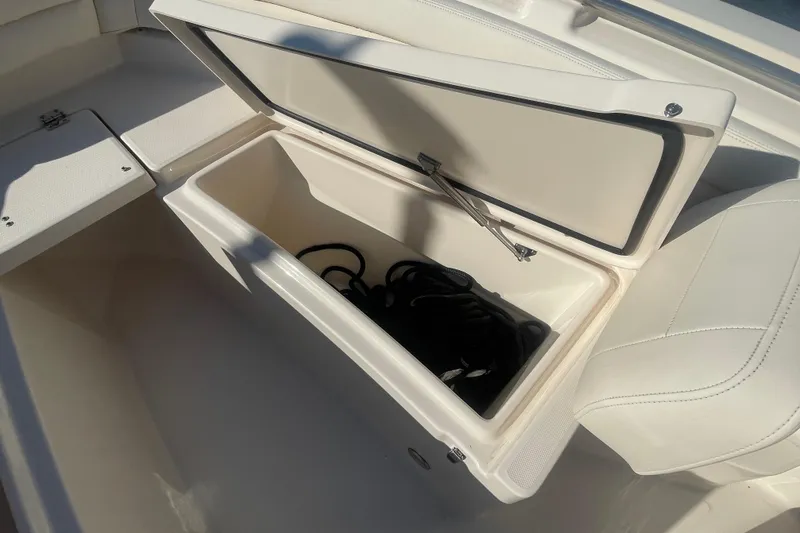 Slide: The Image of 2023 Grady-White Fisherman 236 boat storage compartment with open lid and interior view. - 13