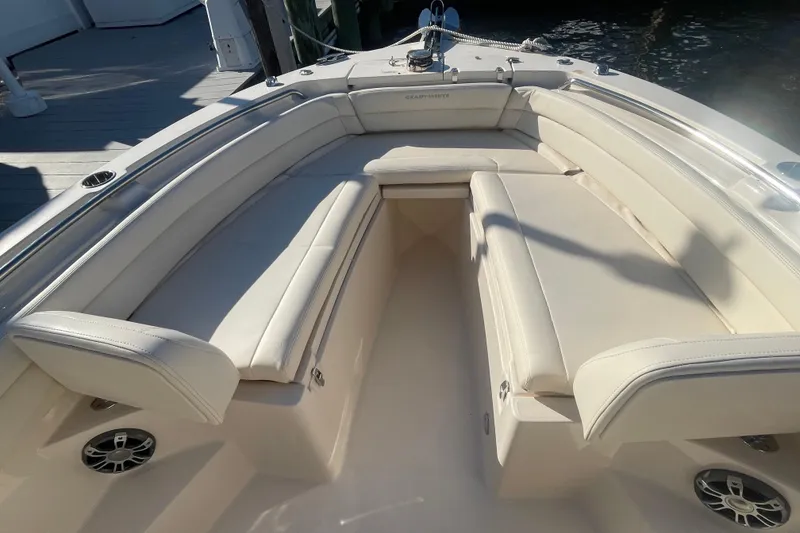 Slide: The Image of 2023 Grady-White Fisherman 236 boat interior with cushioned seating and speakers. - 14
