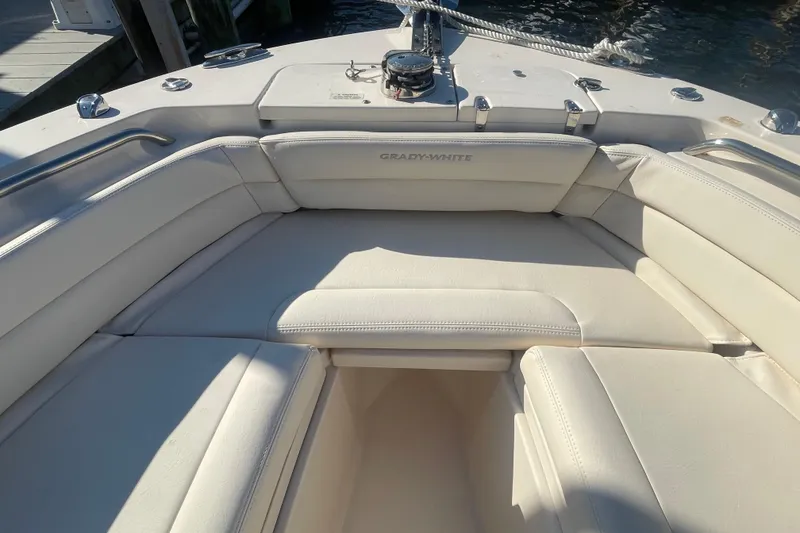 Slide: The Image of 2023 Grady-White Fisherman 236 boat interior with white cushioned seating. - 16