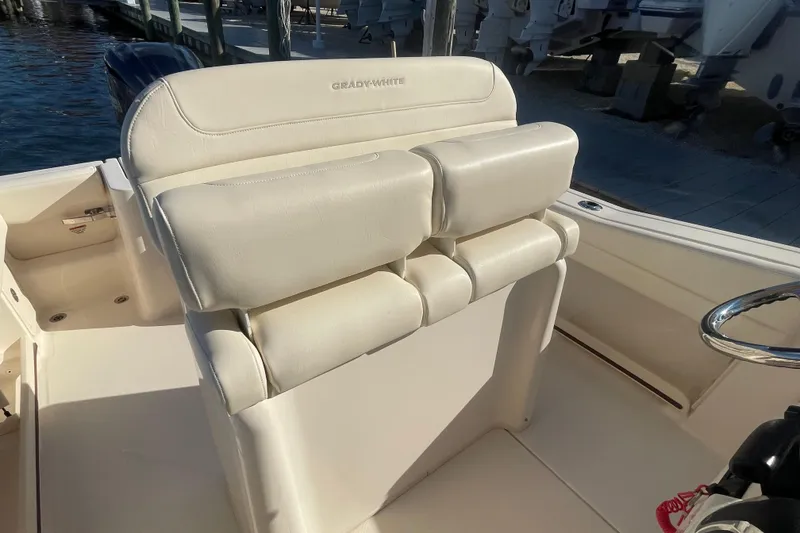 Slide: The Image of 2023 Grady-White Fisherman 236 boat with plush white seating and steering wheel. - 23