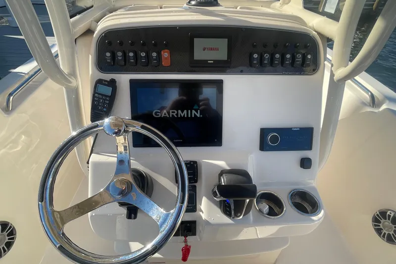 Slide: The Image of 2023 Grady-White Fisherman 236 dashboard with Garmin display and Yamaha controls. - 24