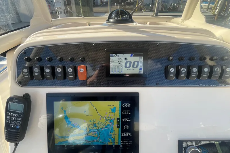 Slide: The Image of 2023 Grady-White Fisherman 236 dashboard with navigation and control panels. - 25