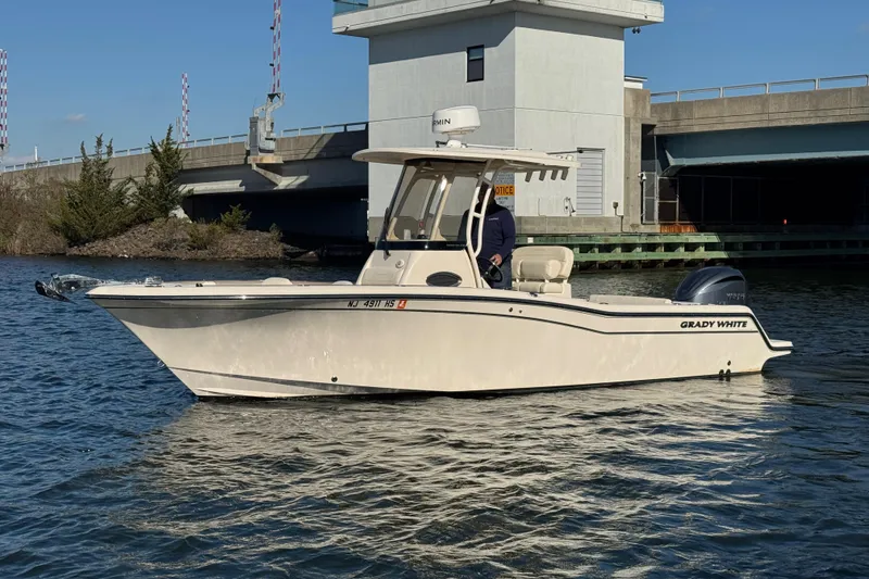 Slide: The Image of 2023 Grady-White Fisherman 236 boat on water near a bridge. - 3