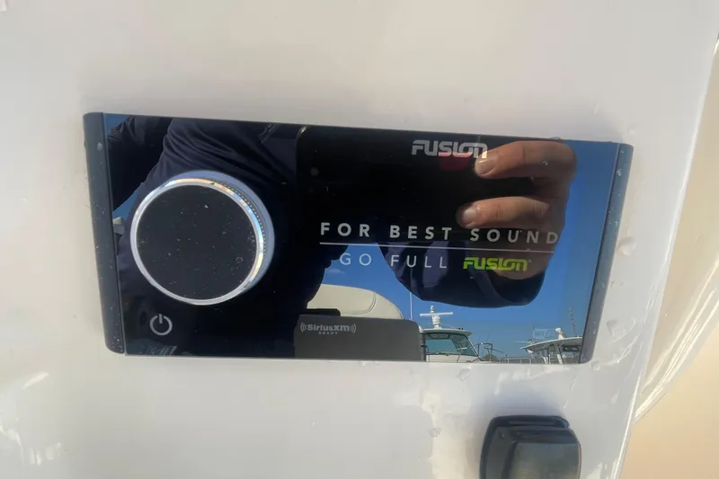 Slide: The Image of Fusion audio system on 2023 Grady-White Fisherman 236 boat, featuring SiriusXM compatibility. - 32