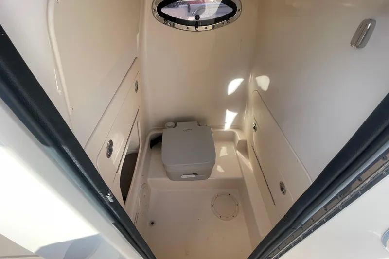 Slide: The Image of 2023 Grady-White Fisherman 236 boat interior with compact marine toilet. - 34