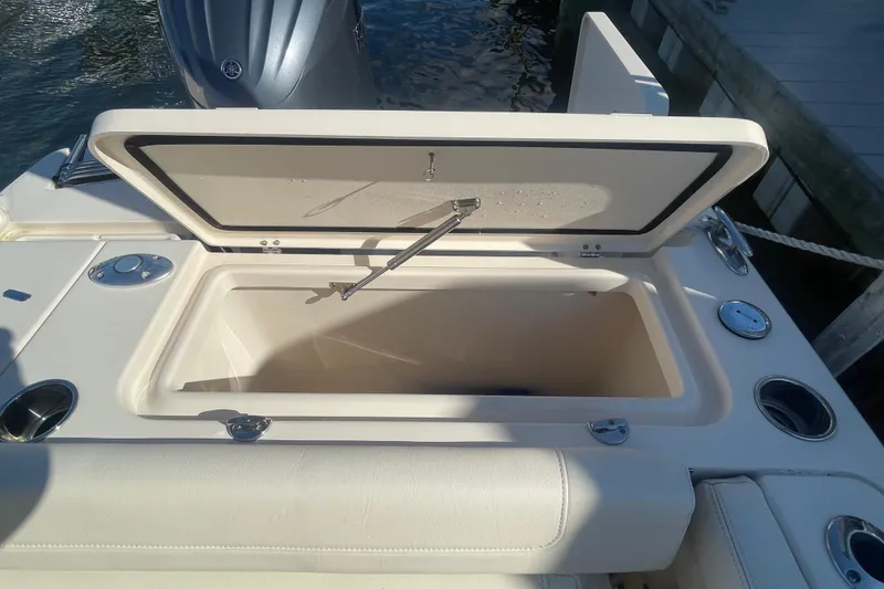 Slide: The Image of Open storage compartment on 2023 Grady-White Fisherman 236 boat, dockside view. - 36