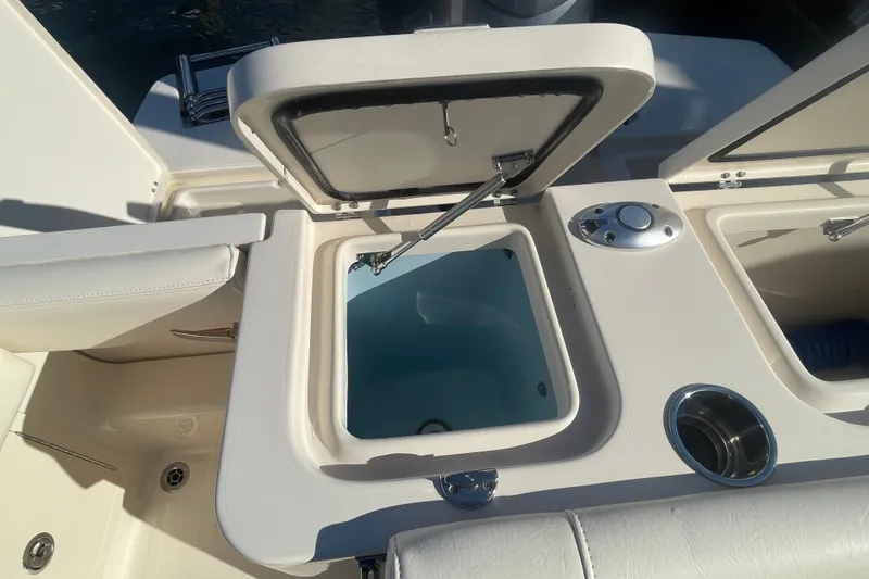 Slide: The Image of 2023 Grady-White Fisherman 236 boat with open storage compartment and cup holder. - 37