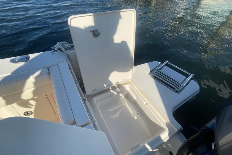 Slide: The Image of 2023 Grady-White Fisherman 236 boat with open storage compartment and ladder by the water. - 39