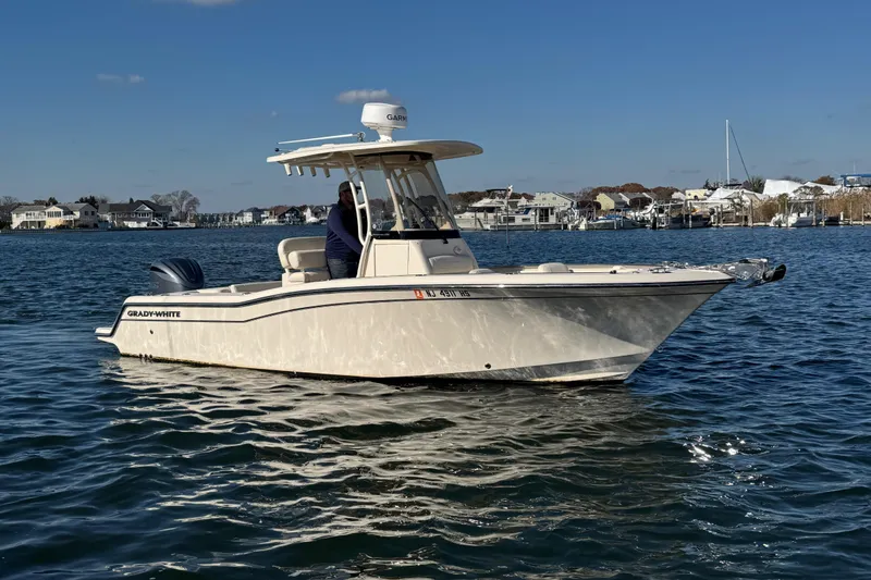 Slide: The Image of 2023 Grady-White Fisherman 236 boat on calm water, clear sky background. - 4