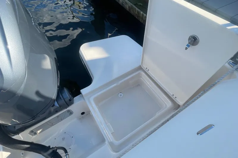 Slide: The Image of 2023 Grady-White Fisherman 236 boat with open storage compartment near engine. - 40