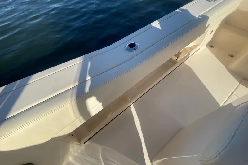 Slide: The Image of 2023 Grady-White Fisherman 236 boat interior with seating and rod holder, on calm water. - 41