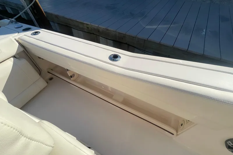 Slide: The Image of 2023 Grady-White Fisherman 236 boat interior with cushioned seating and rod holders. - 42