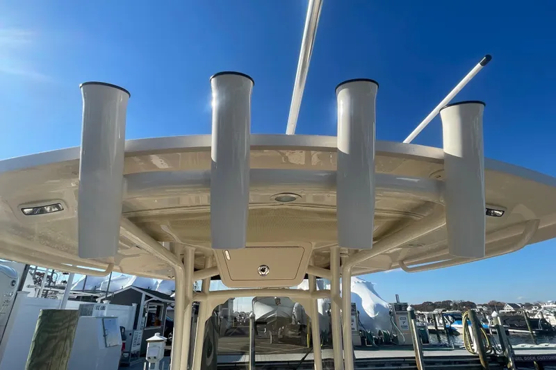 Slide: The Image of 2023 Grady-White Fisherman 236 boat with rod holders, docked under clear blue sky. - 44