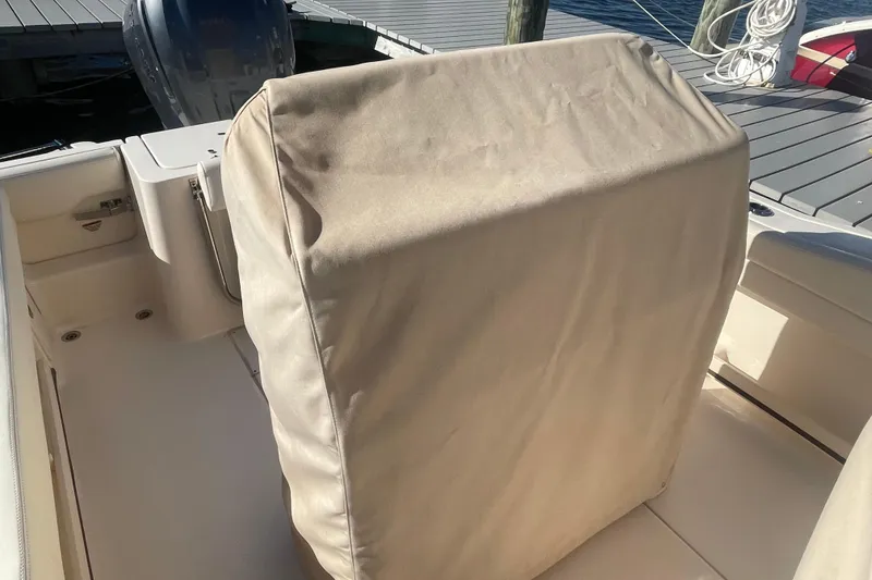 Slide: The Image of 2023 Grady-White Fisherman 236 boat with covered console, docked by the water. - 45