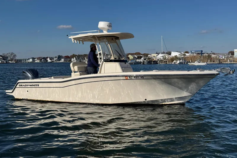 Slide: The Image of 2023 Grady-White Fisherman 236 boat on calm water, clear sky background. - 5