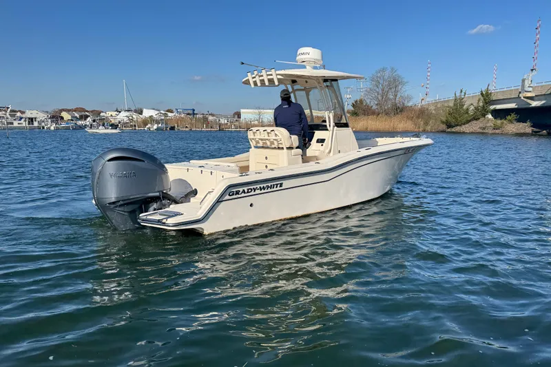 Slide: The Image of 2023 Grady-White Fisherman 236 boat on water, clear sky, coastal background. - 6