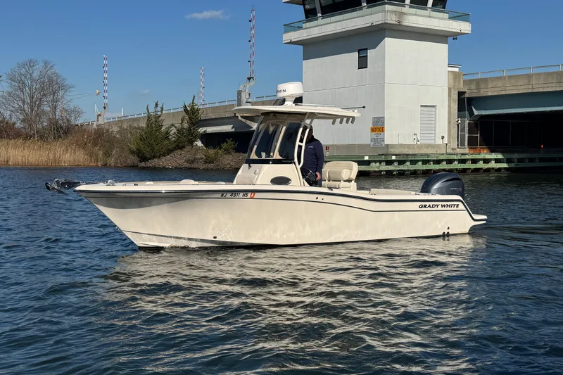 Slide: The Image of 2023 Grady-White Fisherman 236 boat on water near a bridge. - 7