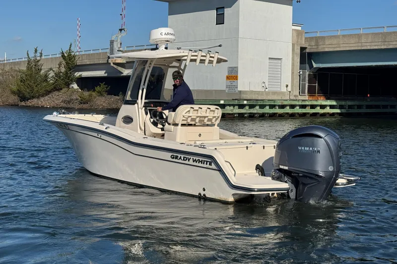 Slide: The Image of 2023 Grady-White Fisherman 236 boat on water near a bridge, featuring Yamaha outboard engine. - 8
