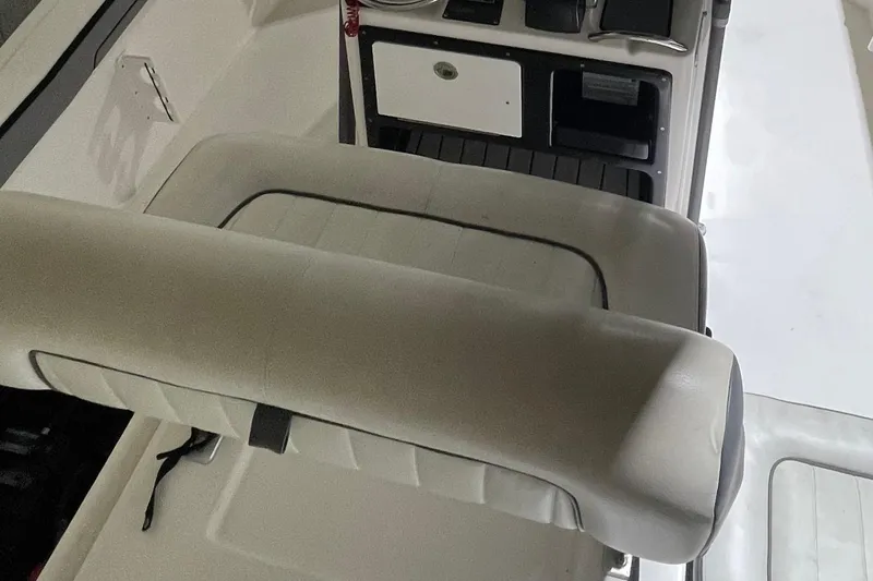 Slide: The Image of 2019 Yamaha Boats 210 FSH interior with cushioned seating and control panel. - 5