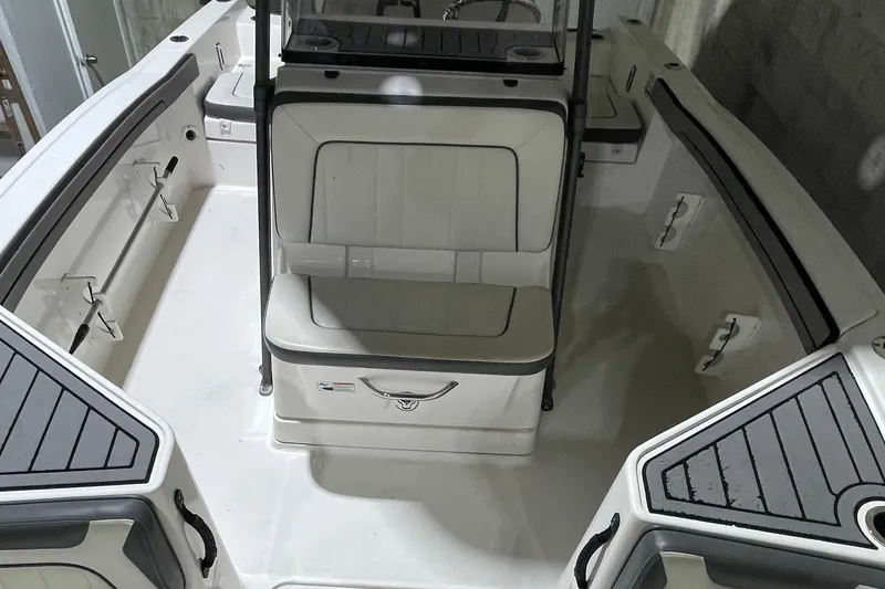 Slide: The Image of 2019 Yamaha Boats 210 FSH interior with seating and storage compartments. - 6