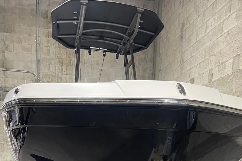 Slide: The Image of 2019 Yamaha Boats 210 FSH in a garage, showcasing sleek design and sturdy build. - 7