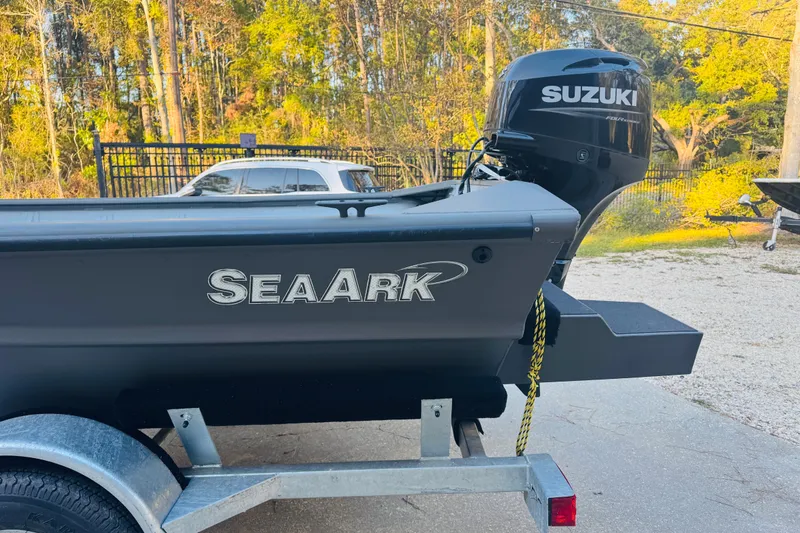 Slide: The Image of 2025 SeaArk 1660 MVT boat with Suzuki outboard motor on a trailer. - 16