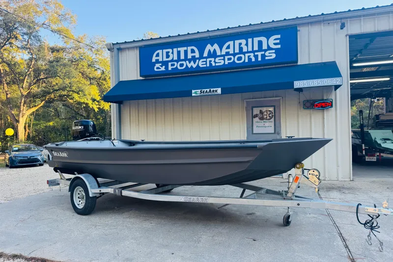 Slide: The Image of 2025 SeaArk 1660 MVT boat on trailer at Abita Marine & Powersports dealership. - 2