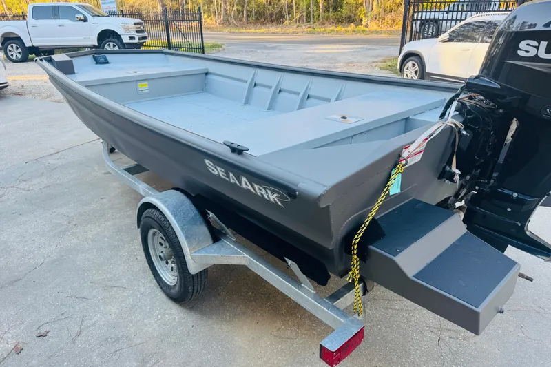 Slide: The Image of 2025 SeaArk 1660 MVT boat on trailer, featuring a sleek gray design and outboard motor. - 4
