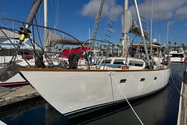 The Image of 1973 Maple Leaf Center Cockpit sailboat docked at marina under clear blue sky. - 1