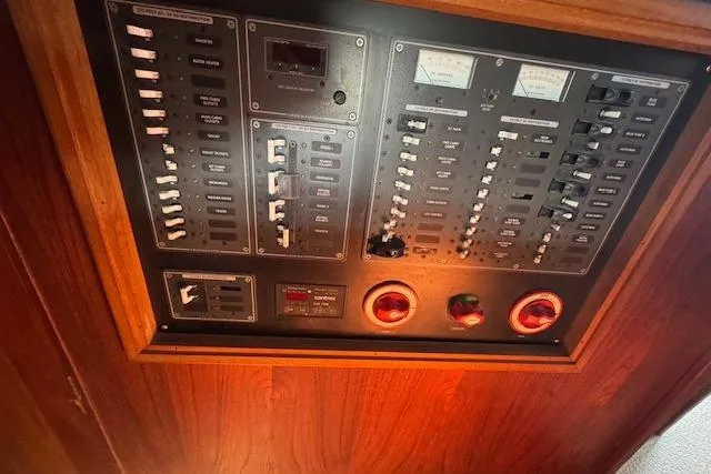 Slide: The Image of 1973 Maple Leaf Center Cockpit control panel with switches and gauges in wooden frame. - 11