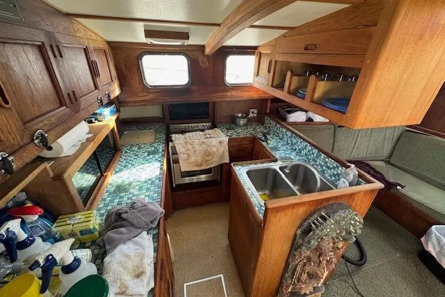 Slide: The Image of 1973 Maple Leaf Center Cockpit interior with wooden cabinetry and tiled countertops. - 13