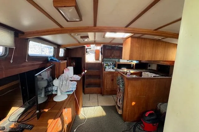 Slide: The Image of Interior of a 1973 Maple Leaf Center Cockpit sailboat with wooden cabinetry and modern amenities. - 16