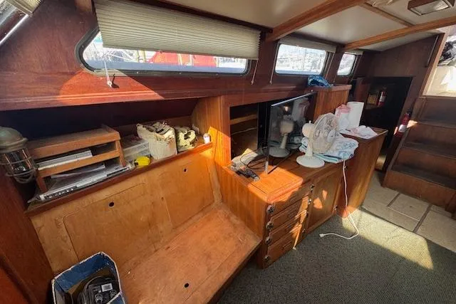 Slide: The Image of 1973 Maple Leaf Center Cockpit interior with wooden cabinetry and nautical decor. - 17