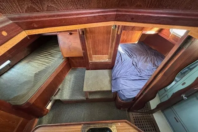 Slide: The Image of 1973 Maple Leaf Center Cockpit interior with wooden finish and cozy sleeping area. - 20