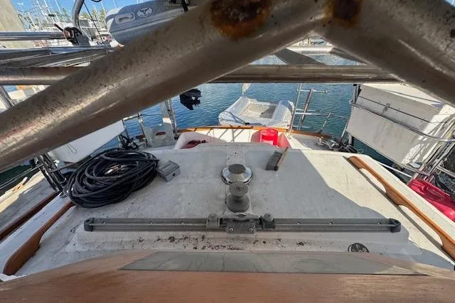 Slide: The Image of 1973 Maple Leaf Center Cockpit sailboat deck with winch and marina view. - 21