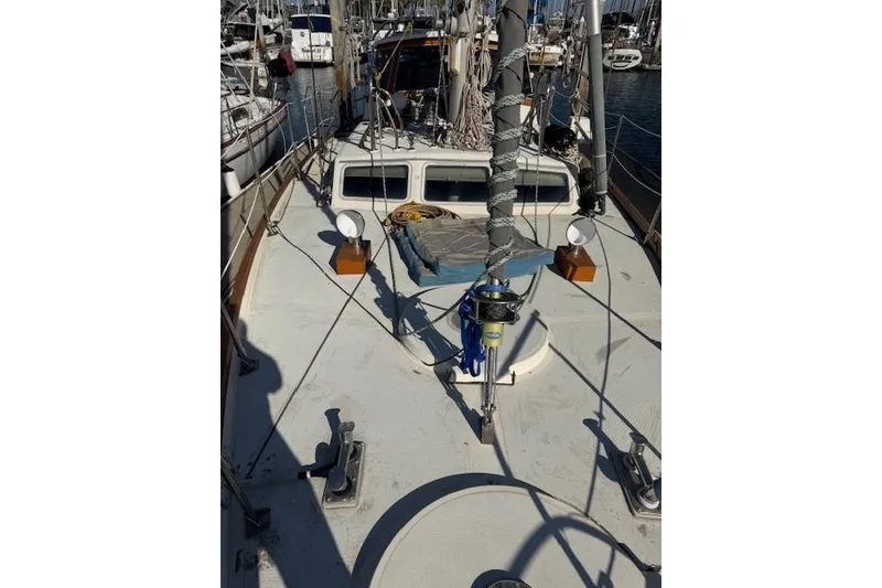 Slide: The Image of 1973 Maple Leaf Center Cockpit sailboat deck with rigging and equipment in marina. - 25