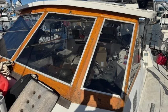 Slide: The Image of 1973 Maple Leaf Center Cockpit sailboat with wooden trim, docked at a marina. - 27
