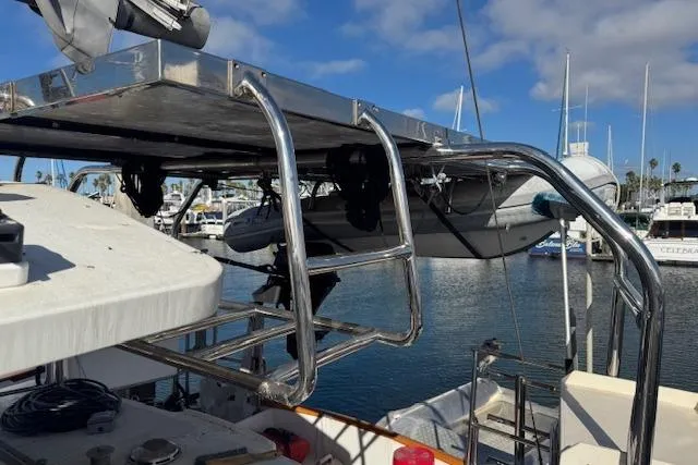Slide: The Image of 1973 Maple Leaf Center Cockpit sailboat with stainless steel davits and dinghy at marina. - 28