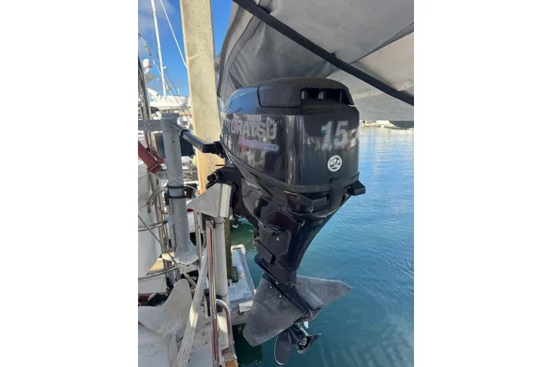 Slide: The Image of Outboard motor on a 1973 Maple Leaf Center Cockpit sailboat, docked at a marina. - 32
