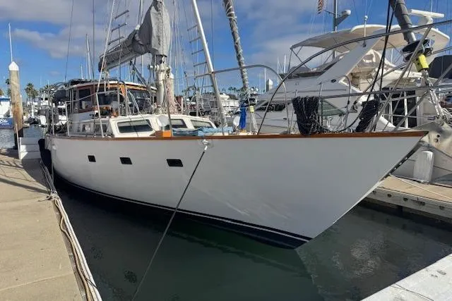 Slide: The Image of 1973 Maple Leaf Center Cockpit sailboat docked at a marina under a clear sky. - 5