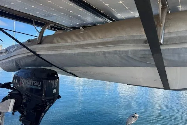 Slide: The Image of A 1973 Maple Leaf Center Cockpit boat with a Tohatsu outboard motor and inflatable dinghy. - 6