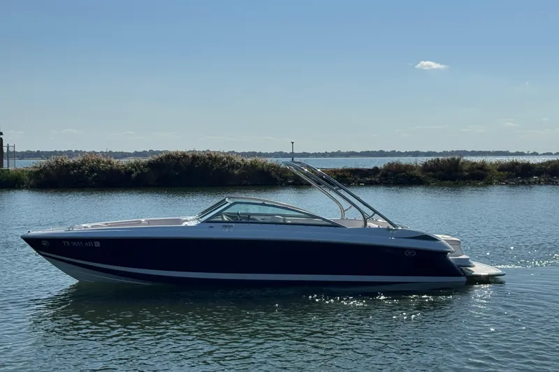 The Image of 2006 Cobalt 272 boat on calm water under clear blue sky. - 1