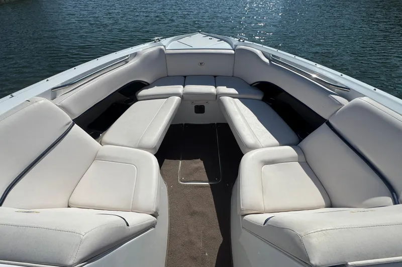 Slide: The Image of 2006 Cobalt 272 boat interior with white seating, on calm water. - 10