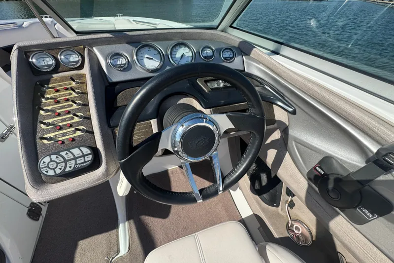 Slide: The Image of 2006 Cobalt 272 boat dashboard with steering wheel and control panel. - 17