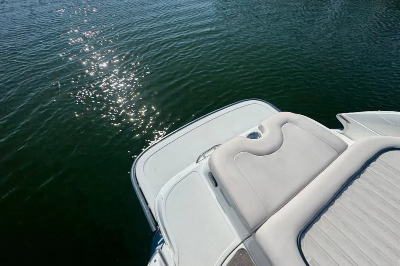 Slide: The Image of 2006 Cobalt 272 boat with sun pad, sparkling water in background. - 22