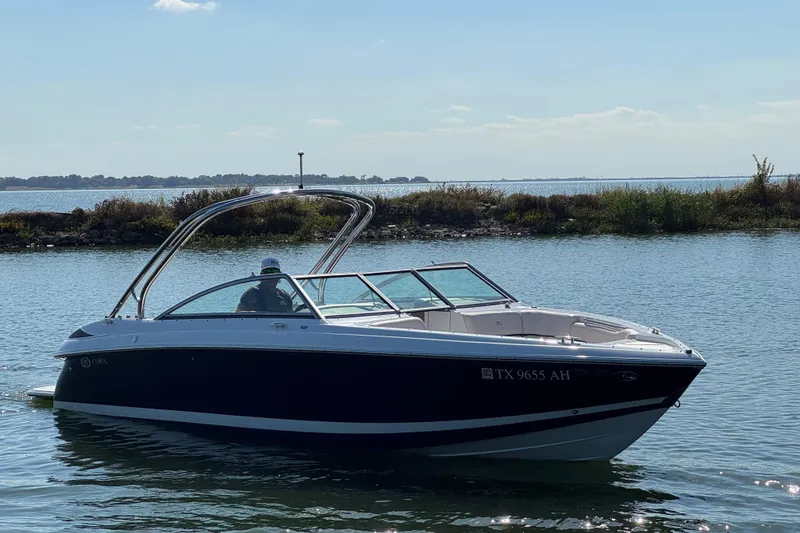 Slide: The Image of 2006 Cobalt 272 boat on calm water with scenic background. - 4