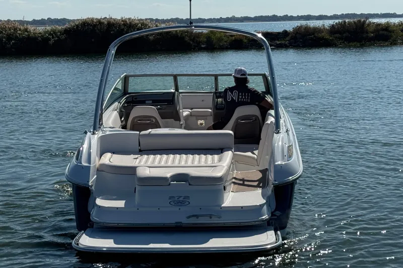 Slide: The Image of 2006 Cobalt 272 boat on water, rear view with driver, sunny day. - 7